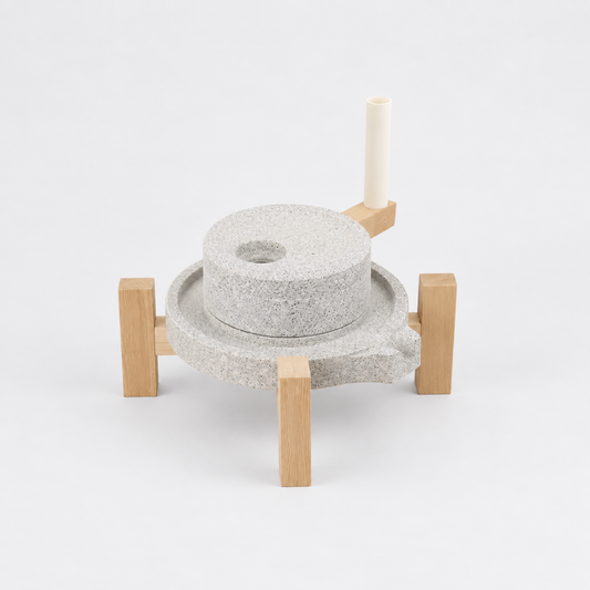 Japanese matcha stone mill (ishi-usu) on wooden frame